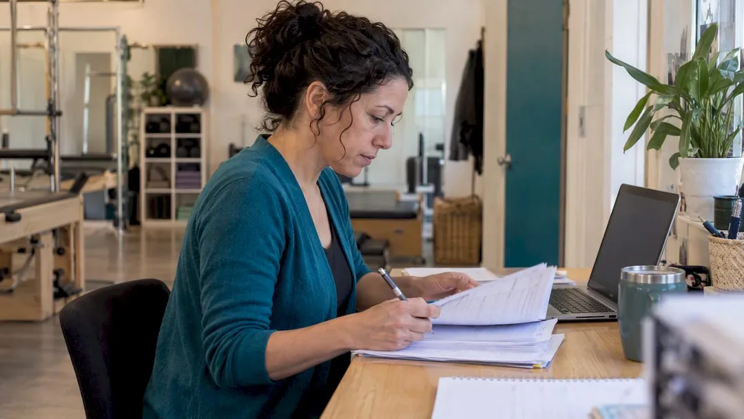 Studio owner checking exported records for migration
